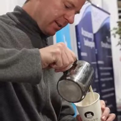 D4 Coffee Ltd barista pouring freshly made coffee into a branded cup
